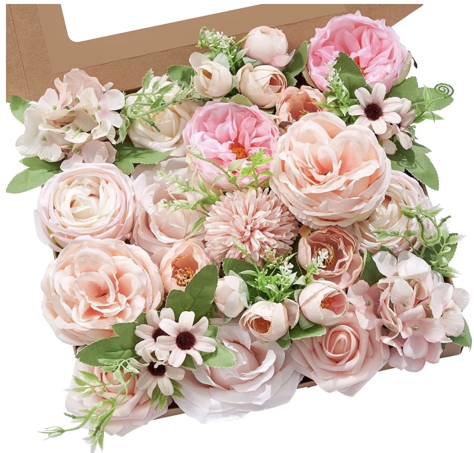 A flat box filled with assorted artificial flowers in soft pink, blush, and cream shades—including roses, peonies, daisies, and greenery—arranged neatly for display or as inspiration for my favorite flower crafts or thoughtful gift giving.